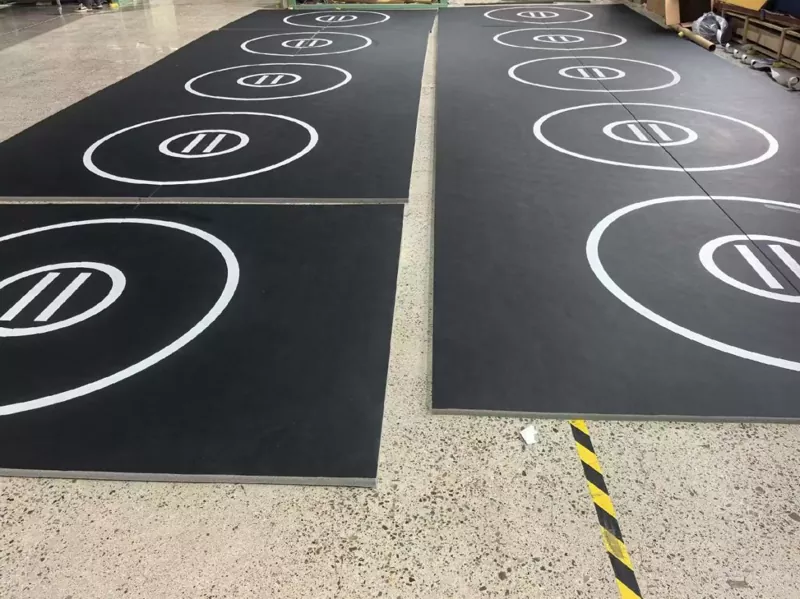 Roll‑out mats fully installed across a BJJ training zone – customer installation photo showing seamless layout and flat surface